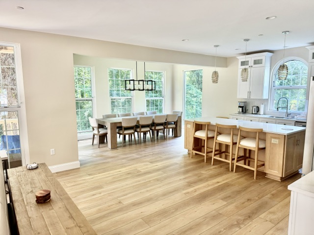 Light-filled gathering space surrounded by trees